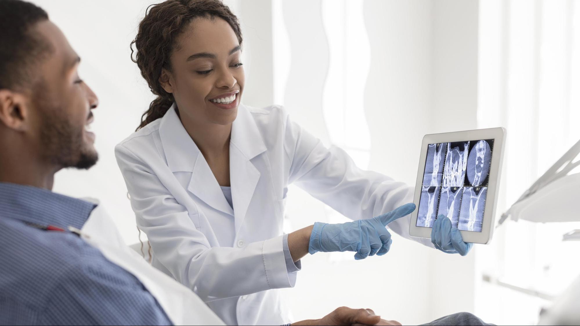 Dentist showing x-rays to a patient.